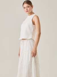 Esta blusa sin mangas refleja una elegancia natural con su cuello redondeado y acabado suave. El diseño se enfoca en la simplicidad, resaltando su frescura y ligereza. Perfecta para combinar con faldas o pantalones, ofrece una versatilidad ideal para días cálidos o eventos casuales.

Detalles:

Color: Blanco Perla

Material: 100% lino. 