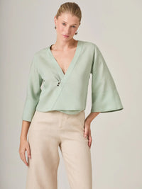 Blusa verde menta diseñada para mujeres que buscan elegancia natural. Su silueta relajada y mangas amplias la hacen perfecta para looks relajados con un acabado pulido y moderno.