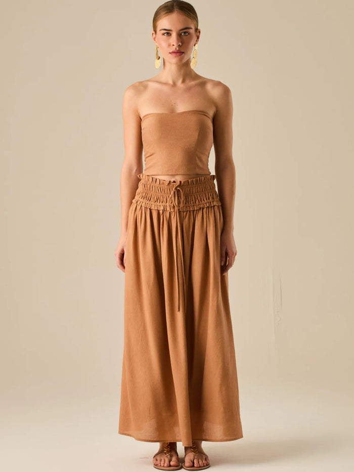 Falda larga de tiro alto con pretina fruncida y lazo ajustable, ideal para un look relajado con elegancia sutil. Su caída fluida y textura ligera aportan movimiento y frescura, perfecta para estilismos sofisticados con esencia natural.

Detalles:

Color: Camel

Material: 82% Rayon 18% Nylon