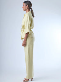 Pantalón de corte recto con diseño de pierna ancha, confeccionado en un tejido ligero que aporta caída fluida. De tiro alto, ofrece una silueta alargada y elegante. No lleva bolsillos visibles ni pinzas, lo que refuerza su apariencia limpia y pulida. Ideal para combinar con camisas o blusas sueltas para un estilo sofisticado y relajado.

Detalles:

Color: Ivory

Material: 50% lino 50% Rayon