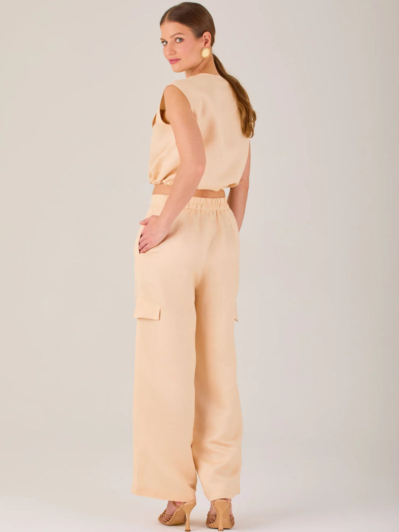 Este pantalón de corte recto y silueta ancha tiene un diseño tipo cargo, con bolsillos de solapa a los costados de las piernas que aportan un toque utilitario. La pretina combina funcionalidad y estilo: es parcialmente elástica en la parte posterior para mayor comodidad, mientras que el frente incluye cierre con botón y pinzas que añaden estructura. Su diseño equilibra lo casual y lo sofisticado, ideal para looks versátiles.